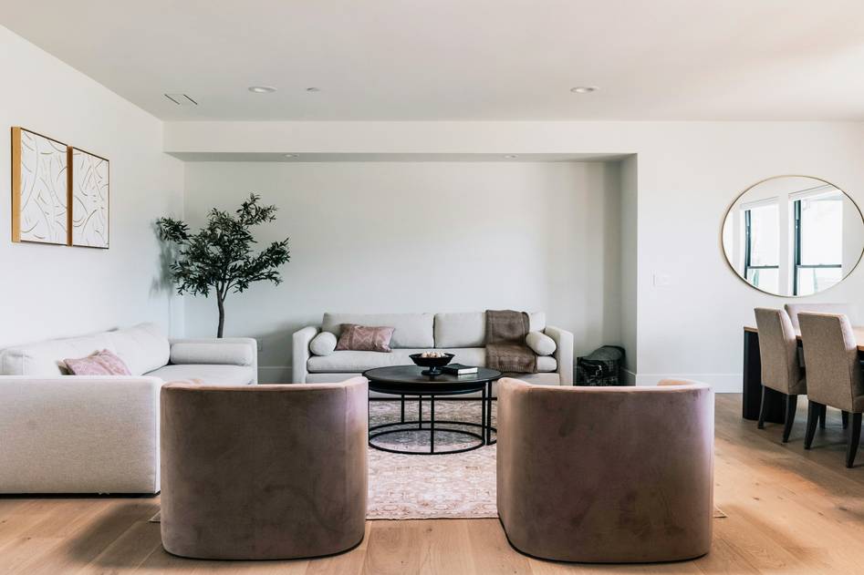 Minimal Home blog founder sketching a furniture layout in a sunlit studio