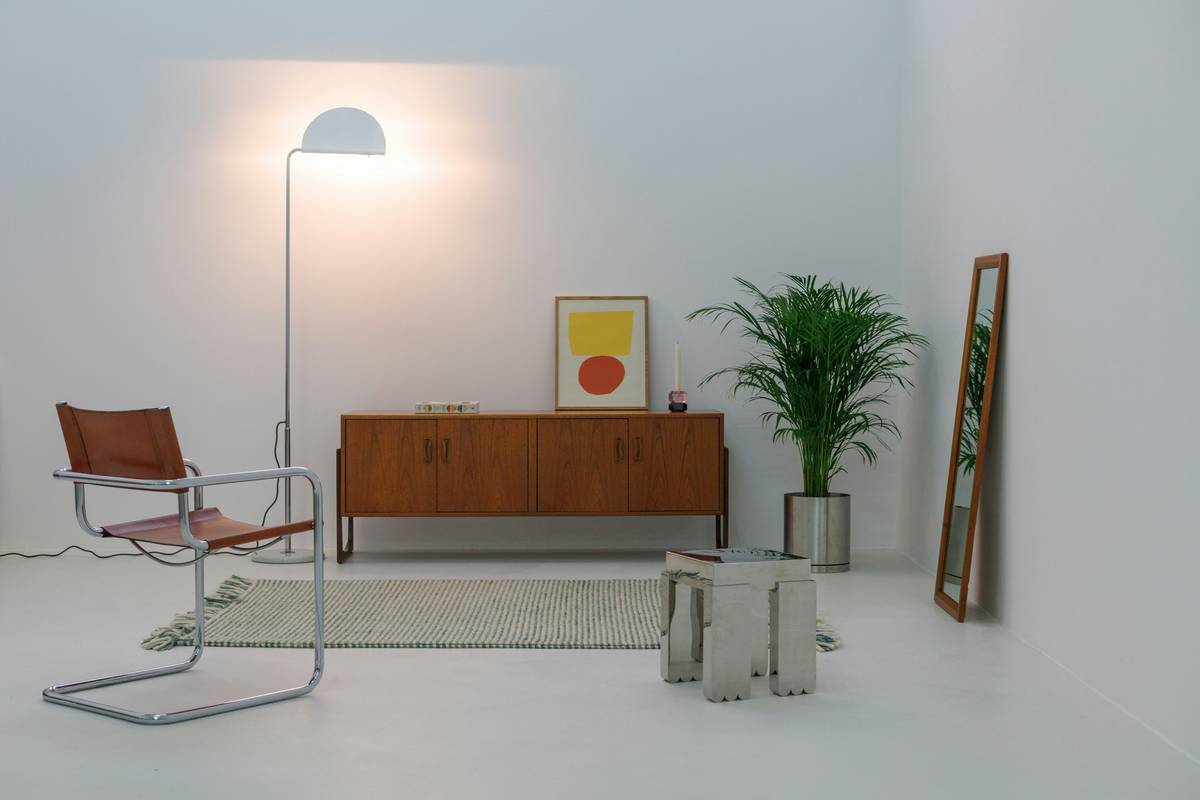 what is minimalist furniture: a clean-lined sofa and wooden coffee table in a sunlit, uncluttered living room
