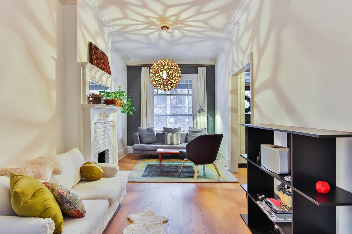 minimalist living room furniture ideas featuring a neutral-toned sofa, wooden coffee table, and open floor space