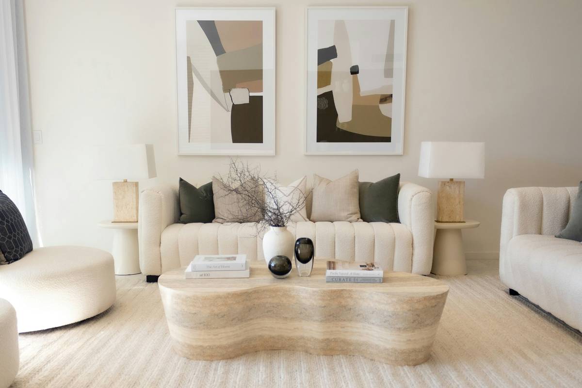 minimalist living room furniture arranged in a sunlit room with a low-profile sofa, wooden coffee table, and neutral-toned rug